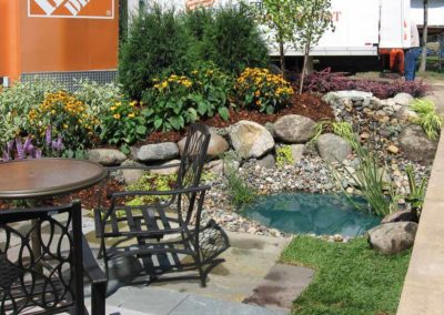 Water fountain and patio landscaping by Greenside Inc in Savage, MN.