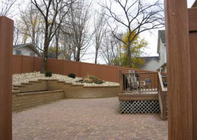 Backyard landscaping with bricks by Greenside Inc in Savage, MN.