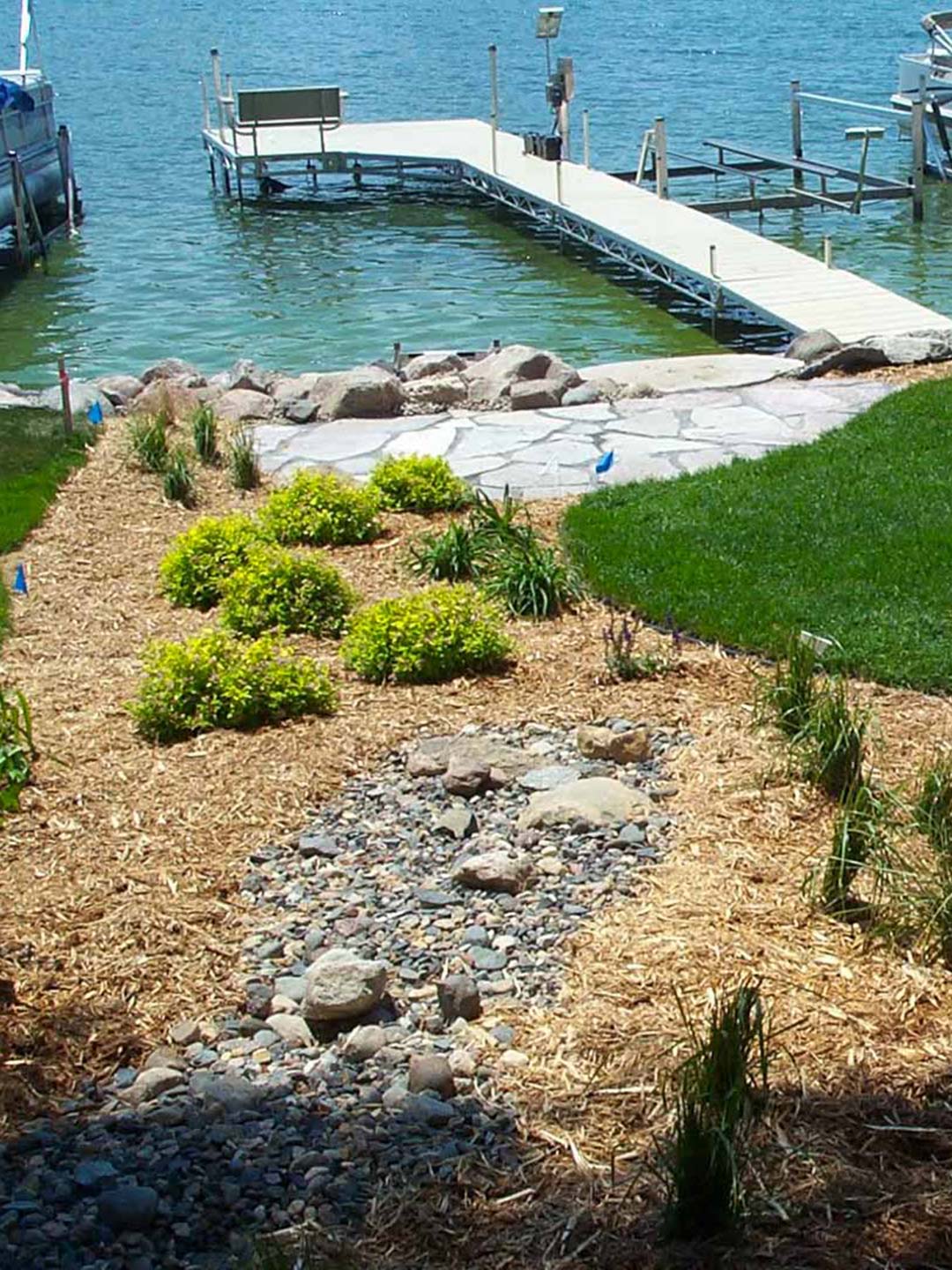 Residential waterfront landscaping by Greenside Inc in Savage, MN.